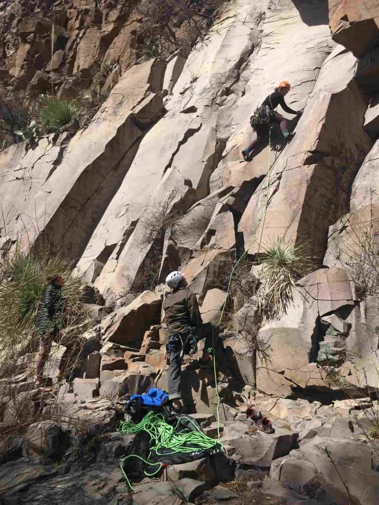 rock climber starts the slab up the trad barbershop cafe percha creek in sierra county nm