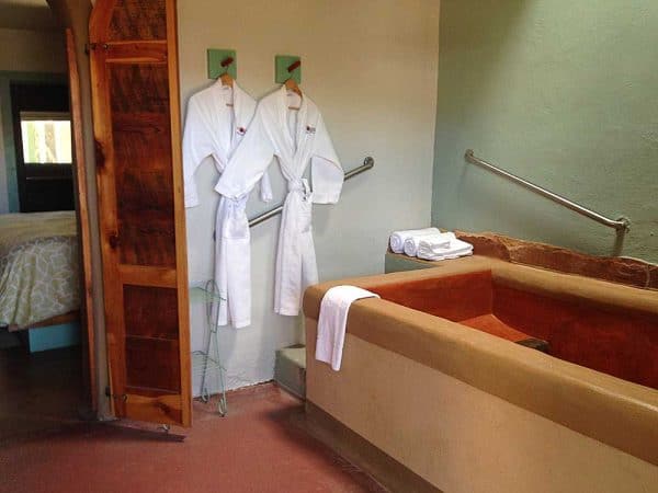 Blackstone Hotsprings - Golden Girls bath with king bed in the background.