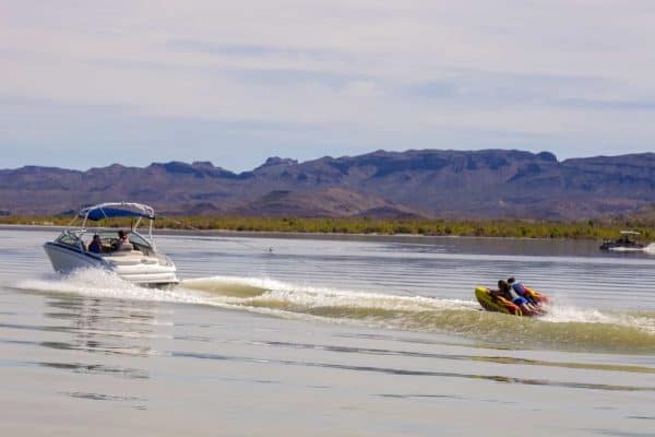 boat towing inflatable tubes at elephant butte lake